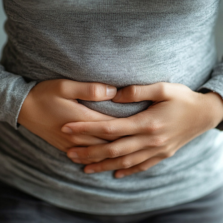 Woman with Irritable Bowel Syndrome holding her tummy 